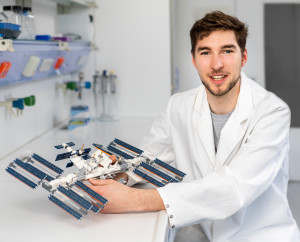 Thibaut Vignane holding a model of the International Space Station.