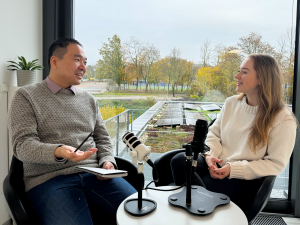 Dr. Jianxu Chen and Podcast Host Cheyenne Peters at a table, recording the podcast.
